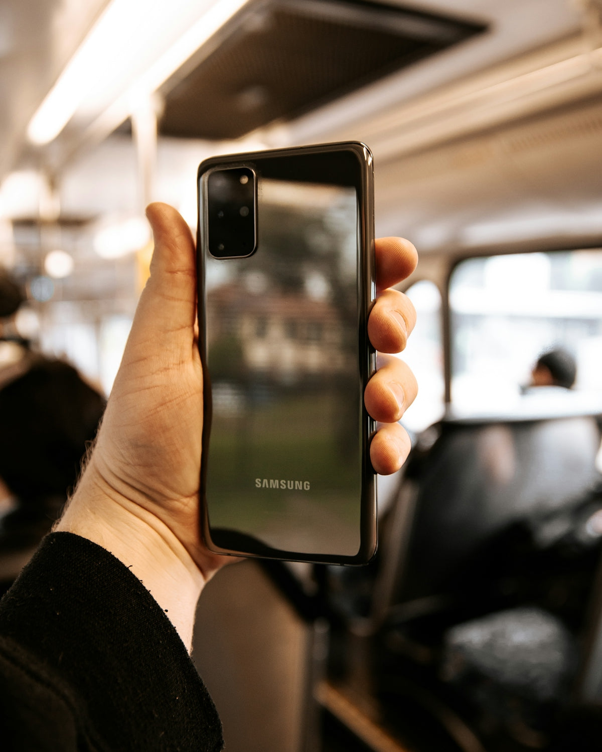 person holding black iphone 4